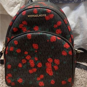 Only used a few times! Michael kors with red roses!